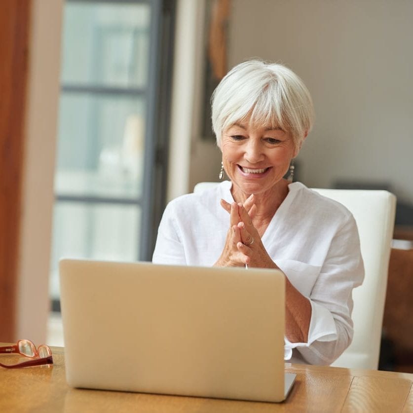 An older woman using a laptop